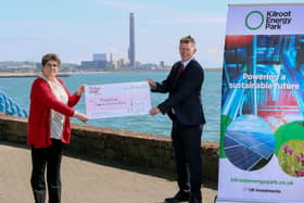 Ian Luney, commercial director of EP UK investments, presenting a cheque for £14,000 to Jackie McCaughey, MindWise area manager for housing support services.