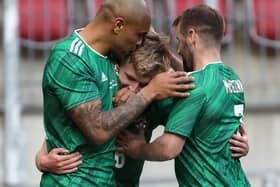 Northern Ireland’s Ali McCann celebrates his goal with Josh Magennis and Niall McGinn