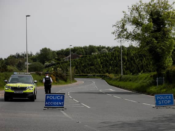 A PSNI officer pictured near the scene of the collision earlier on Tuesday.