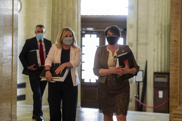 Deputy First Minister Michelle O'Neill and First Minister Arlene Foster make their way to the Assembly chamber at Stormont on Tuesday for Executive Office questions