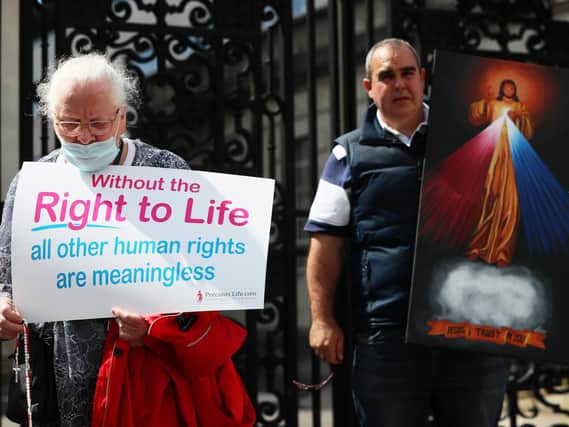 Anti abortion demonstrator prays outside Belfast High Court last month.