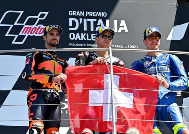 Race winner  Fabio Quatararo, runner-up Miguel Oliveira (left) and Joan Mir hold a Swiss flag in memory of Jason Dupasquier at Mugello on Sunday.