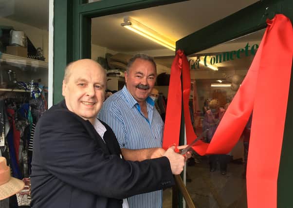 Journalist Paul Rooney cuts the ribbon on the new premises purchased by south Armagh peacemaker Ian Bothwell of Crossfire Trust in Crossmaglen.