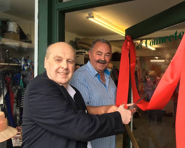 Journalist Paul Rooney cuts the ribbon on the new premises purchased by south Armagh peacemaker Ian Bothwell of Crossfire Trust in Crossmaglen.