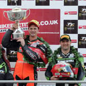 Ryan Farquhar (KMR Kawasaki) celebrates his victory in the Lightweight race at the Isle of Man TT in 2012 with runner-up James Hillier (Bournemouth Kawasaki) and Michael Rutter (KMR Kawasaki). Also included is 11 times TT winner Phillip McCallen who presented the trophy.