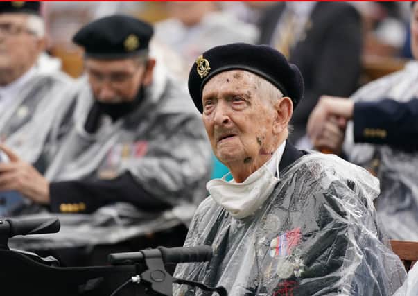 Veterans watch the official opening of the British Normandy Memorial in France via a live feed during a ceremony at the National Memorial Arboretum in Alrewas, Staffordshire. Photo:  Jacob King/PA Wire