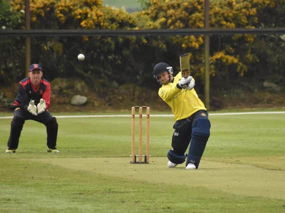 Burndennett's Jason Milligan drives to the boundary in Sunday's lost to Bready. Picture by Lawrence Moore