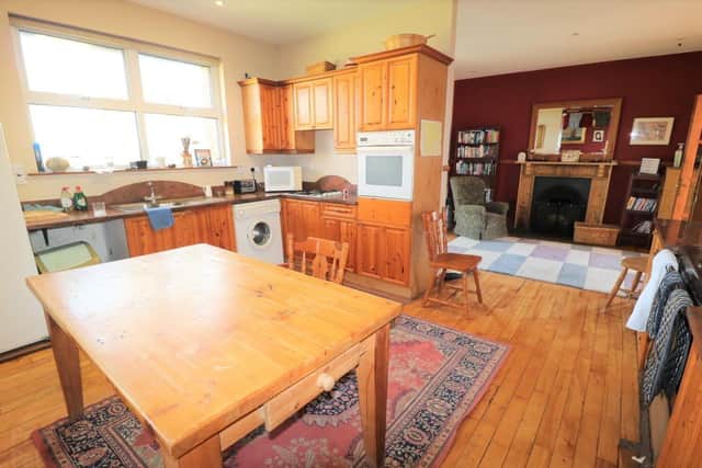 The property has an open plan reception area within the hallway, which opens into the working kitchen