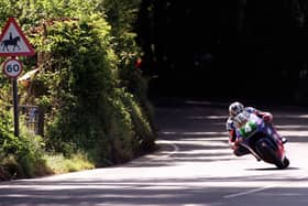 John McGuinness flies through Ballaspur on his way to victory in the Lightweight TT, his first Isle of Man win in 1999.