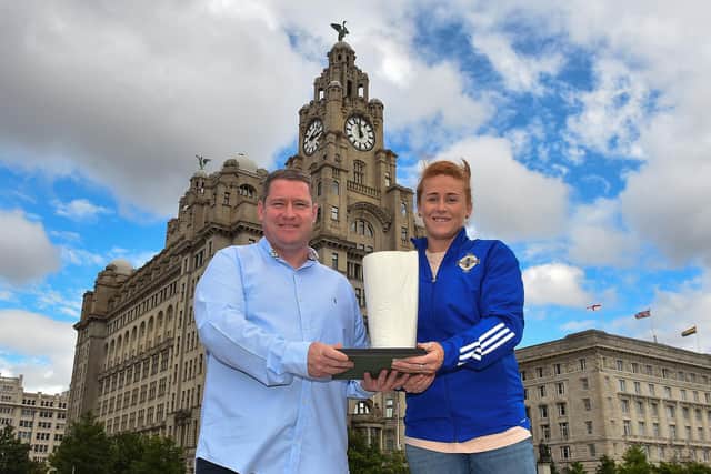 Rachel Furness is pictured receiving the award alongside Liverpool FC Women manager Matt Beard