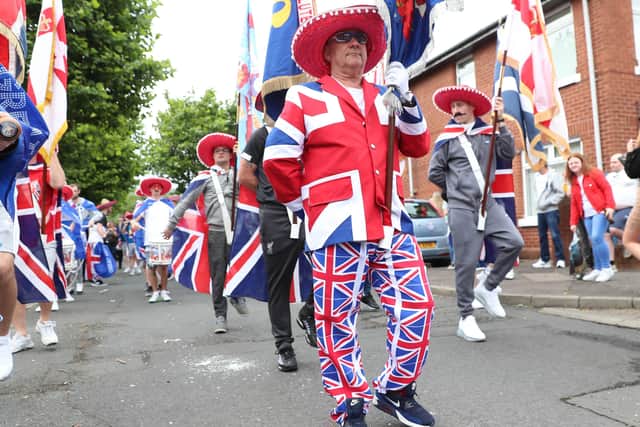 Dressed for the occasion as he leads the First Ulster Flute Band around the Sandy Row of Belfast on July 12, 2020