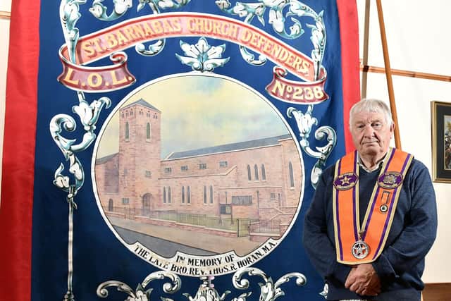 District Master of Bangor District LOL 18 Martyn McCready with an old Orange Lodge banner that has been recently recovered from an attic in Dublin.