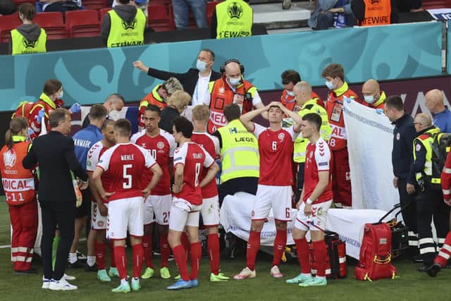 Denmark's players react as their team-mate Christian Eriksen receives treatment during the Euro 2020 match with Finland in Copenhagen on Saturday. Pic by PA.