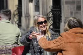 Members of the public enjoy a drink in Belfast. Shops and outdoor hospitality venues reopened across Northern Ireland at the end of April as coronavirus rules were relaxed. Picture date: Friday April 30, 2021.