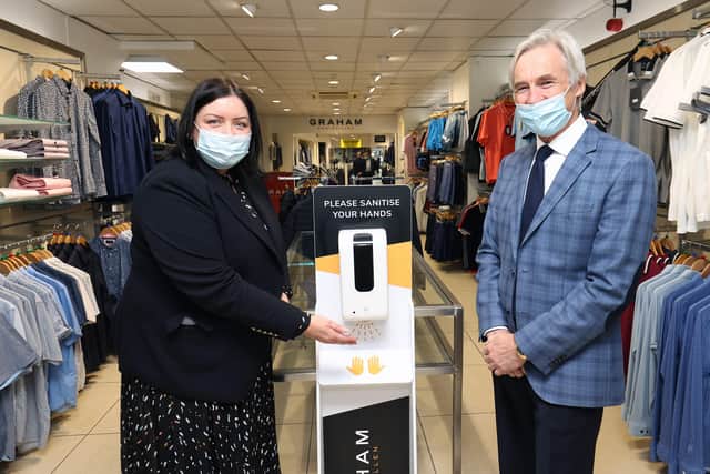 Communities Minister Deirdre Hargey with Bryan Graham of Graham’s of Enniskillen who availed of Covid-19 Revitalise funding for his business to purchase new sanitizing stations and protective screens