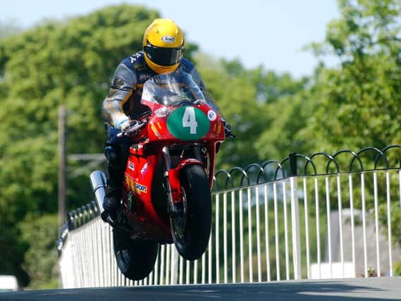 Can you name this rider, the course section and the year the photograph was taken at the Isle of Man TT?