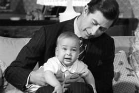 File photo dated 22/12/1982 of Prince Charles cradling his son Prince William at Kensington Palace, London. Issue date: Monday June 21, 2021.