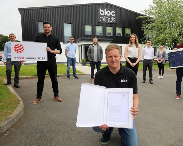 Cormac Diamond, managing director of Bloc Blinds, with staff and the Red Dot Award for product design