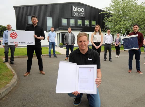 Cormac Diamond, managing director of Bloc Blinds, with staff and the Red Dot Award for product design