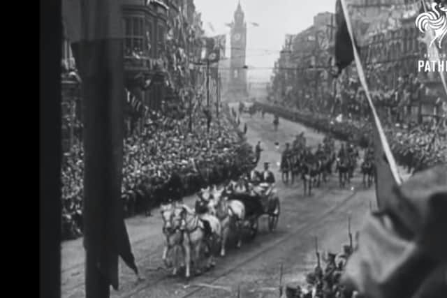 The Royal procession heads from High Street-Castle Place towards Belfast City Hall, with the Albert Clock in the background