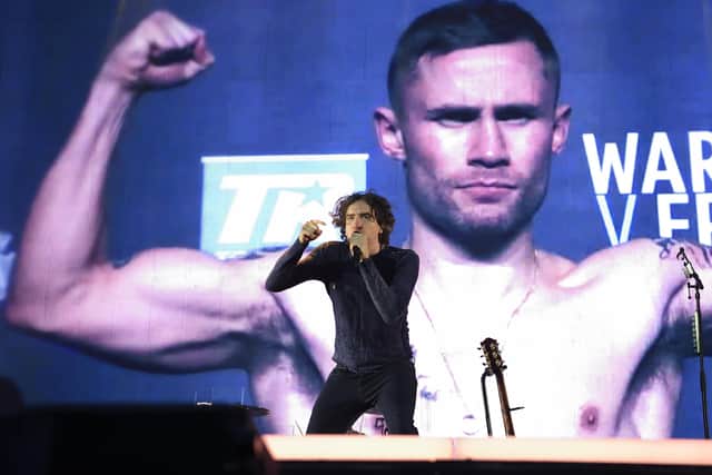 Modern Northern Ireland celebrities. Gary Lightbody of Snow Patrol on stage in front of an image of the boxer Carl Frampton