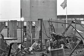 A tattered Union flag flies above the remains of a Magherafelt Army base in early 1991, while a trio of men survey the damage from a 500lb (220kg) IRA proxy bomb. The base had been used by the UDR; there were no fatalities