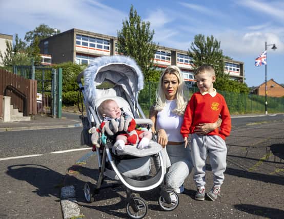 Alice-Lee Bunting who attended Holy Cross Girls' School Belfast 20 years ago during the Holy Cross dispute in Ardoyne, north Belfast walking with her sons Darragh Bunting (4) and Keaghan Tommy Bunting (8 months).