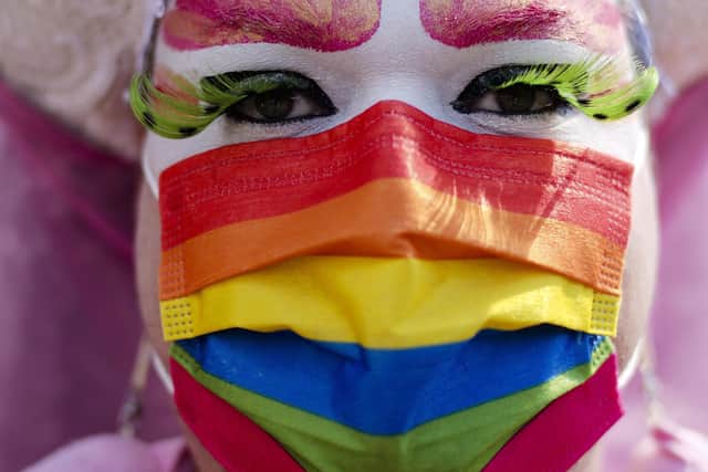 A person with a rainbow colored face mask attends a pride rally for visibility and freedom in Berlin, Germany, Saturday, June 26, 2021. (AP Photo/Markus Schreiber)