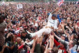 NORTHAMPTON, ENGLAND - JULY 10:  Lewis Hamilton of Great Britain and Mercedes GP crowd surfs with the fans to celebrate his win during the Formula One Grand Prix of Great Britain at Silverstone on July 10, 2016 in Northampton, England.  (Photo by Clive Mason/Getty Images)