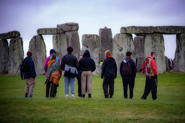 People view the stones during Summer Solstice at Stonehenge, where some people jumped over the fence to enter the stone-circle to watch the sun rise at dawn of the longest day in the UK. Picture date: Monday June 21, 2021