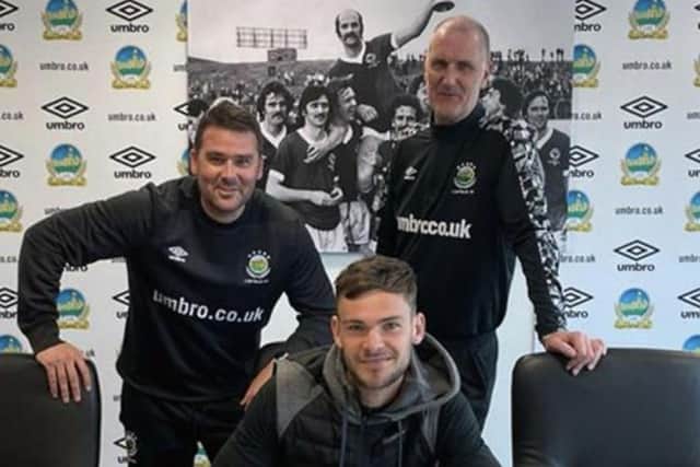 Jack Ruddy signs on at Windsor Park. Picture by Linfield FC
