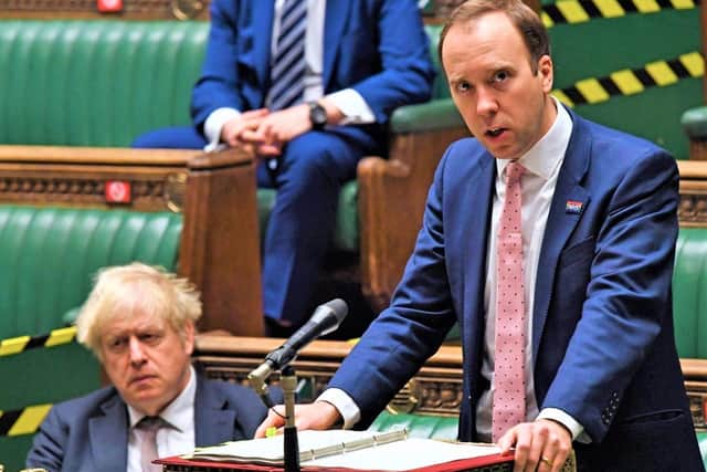 Matt Hancock addressing the House of Commons (while Boris Johnson listens in, left)
