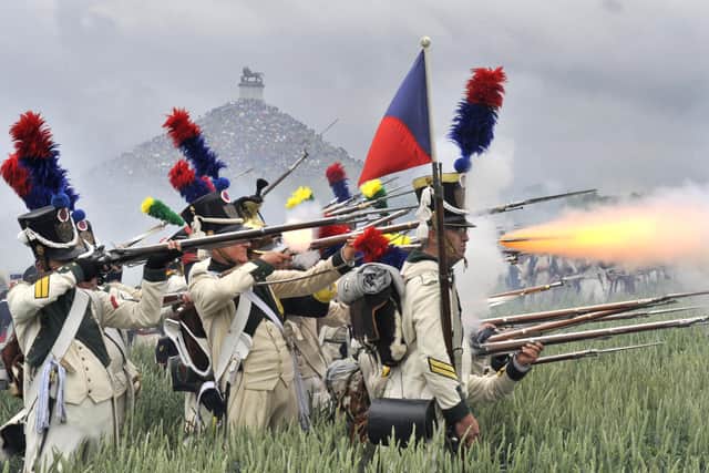 People dressed as soldiers fight during a re-enactment of the 1815 Battle of Waterloo between the French army led by Napoleon and the Allied armies led by the Duke of Wellington and Field-Marshal Blucher, on June 20, 2010, in Waterloo. On June 18, 1815, Napoleon led his 72,000-strong army into battle with 120,000 mostly British and Prussian soldiers on the gently rolling plateau of Waterloo. For a long time the two forces remained in a bloody embrace, but at the end of the afternoon the French emperor's Great Army was routed at the hands of the Duke of Wellington and Field Marshal Bluecher. AFP PHOTO / GEORGES GOBET (Photo credit should read GEORGES GOBET/AFP via Getty Images)
