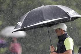 Rory McIlroy shelters under his umbrella during final round of The Dubai Duty Free Irish Open at Mount Juliet Golf Club