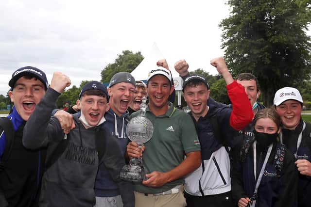 Lucas Herbert (centre) celebrates with the Irish Open trophy as spectators join in the fun. Pic by PA.