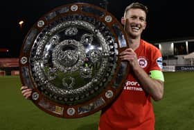 Larne captain Jeff Hughes with the Co Antrim shield.