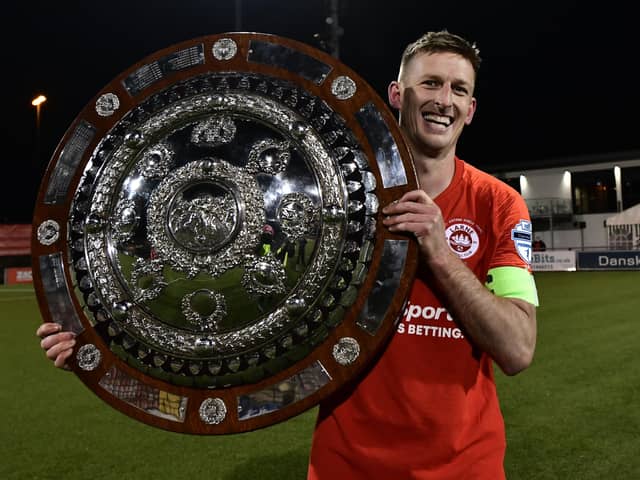 Larne captain Jeff Hughes with the Co Antrim shield.