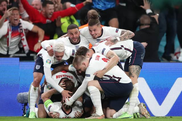 England's Harry Kane is mobbed by team-mates after scoring their side's second goal of the game in extra-time during the UEFA Euro 2020 semi final match at Wembley Stadium, London. Picture date: Wednesday July 7, 2021. PA Photo. See PA story SOCCER England. Photo credit should read: Nick Potts/PA Wire.
 
RESTRICTIONS: Use subject to restrictions. Editorial use only, no commercial use without prior consent from rights holder.