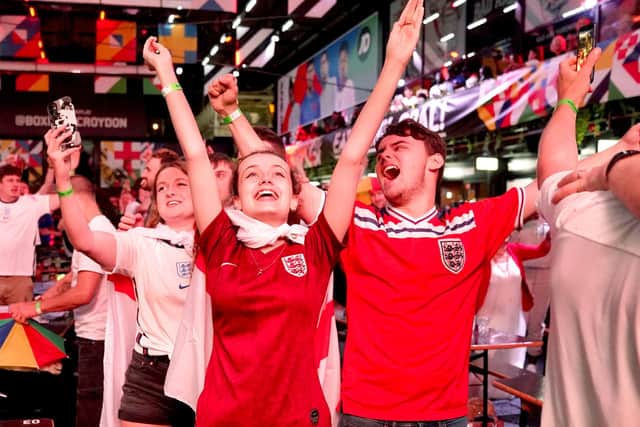 Fans at BOXPARK in Croydon celebrate England reaching the final after watching the Euro 2020 semi final match between England and Denmark. Picture date: Wednesday July 7, 2021. PA Photo. See PA story SPORT England. Photo credit should read: Tess Derry/PA Wire.