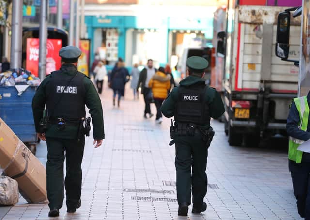 PSNI officers out walking in Belfast. Technology is no substitute for feet in the street