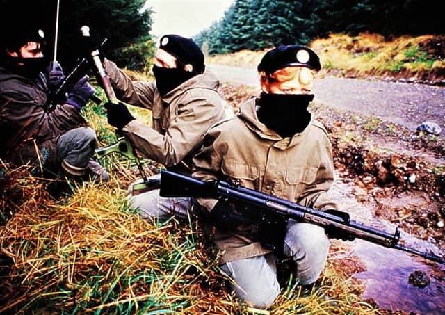 A propaganda photograph showing IRA volunteers on a rural roadway in 1989