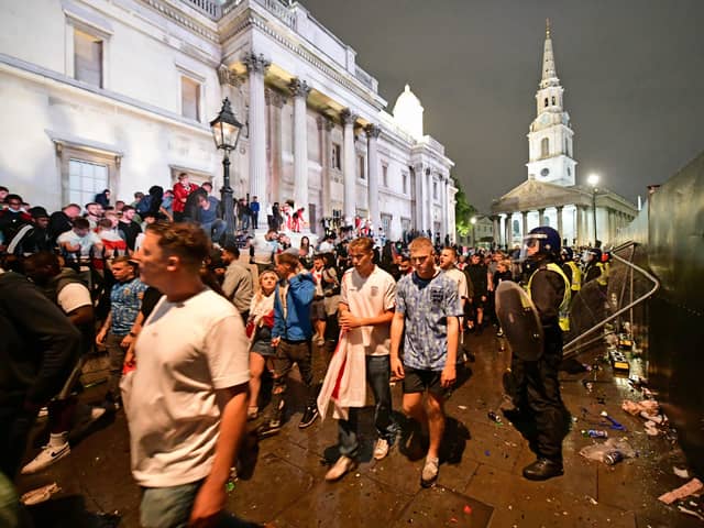 Dejected England fans leave Trafalgar Square, London, after Italy beat England on penalties to win the UEFA Euro 2020 Final
