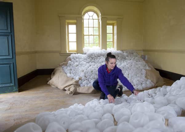 Irish artist Paula Stokes puts the finishing touches to her famine memorial installation in the gardens of Strokestown Park & The National Famine Museum, Roscommon. Photo Brian Farrell