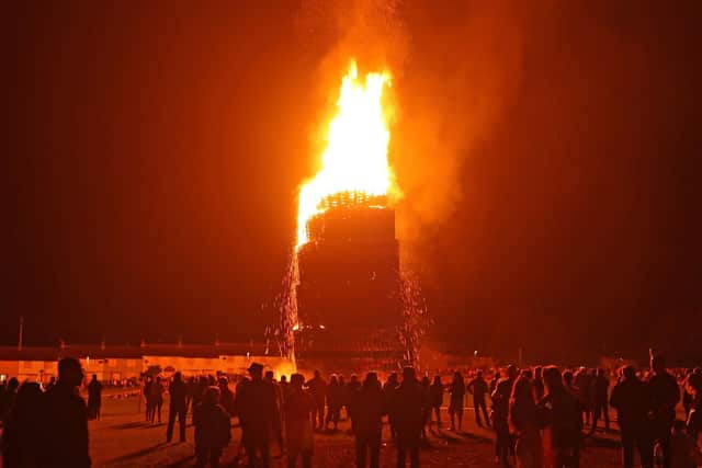 The huge bonfire in Craigyhill, Larne, is lit on the "Eleventh night" to usher in the Twelfth commemorations. Picture date: Monday July 12, 2021.