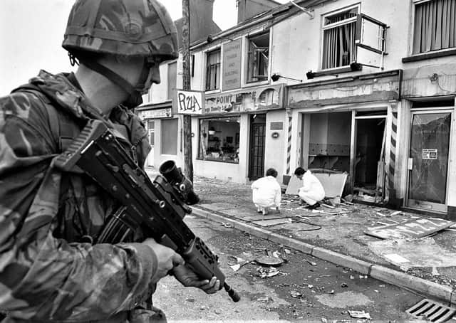 A soldier stands guard after six people are injured in an IRA explosion at a pizzeria in Warrenpoint, 1991