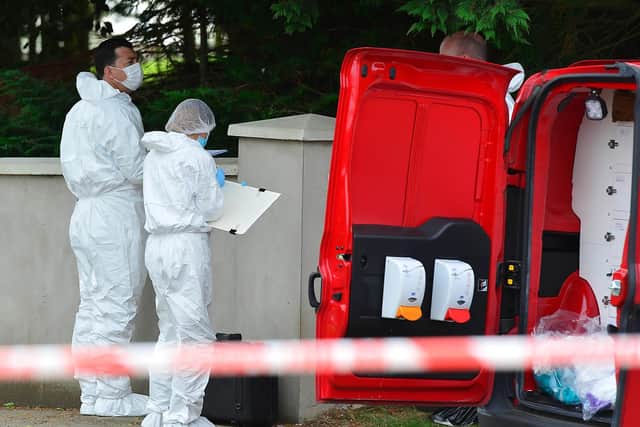 PSNI forensic officers pictured at the scene of the murder on Tuesday.