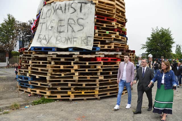 DUP leader Jeffrey Donaldson and his deputy Paula Bradley show their support for the Tiger’s Bay bonfire. Peter Robinson says SDLP and Sinn Fein ministers tried "to circumvent the proper legal processes by failing to bring their controversial and cross-cutting proposal to make an anti-bonfire legal challenge to the Stormont Executive"