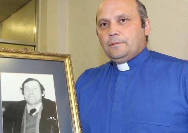 Rev Alan Irwin with a picture of his murdered father Thomas