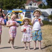 (left to right) Twins Bella and Layla Hughes (4) with Annie Shepherd (2) and her brother Jude Shepherd (5) eating screwball ice creams at Helen's Bay beach in County Down, Northern Ireland. Picture date: Tuesday July 20 2021.
