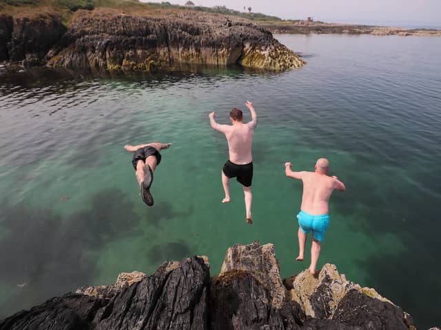 Tristan Brennan, Gary Niblock and Jamie Craig take a dive off the rocks at Orlock, Co Down yesterday as Northern Ireland sweltered again in record-breaking temperatures

Pic: Jonathan Porter/PressEye